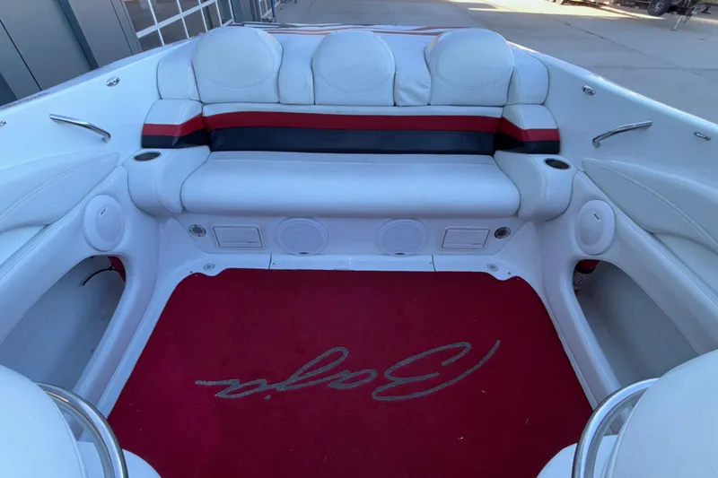 Slide: The Image of 2001 Baja 33 Outlaw boat interior with white seating and red carpet. - 16