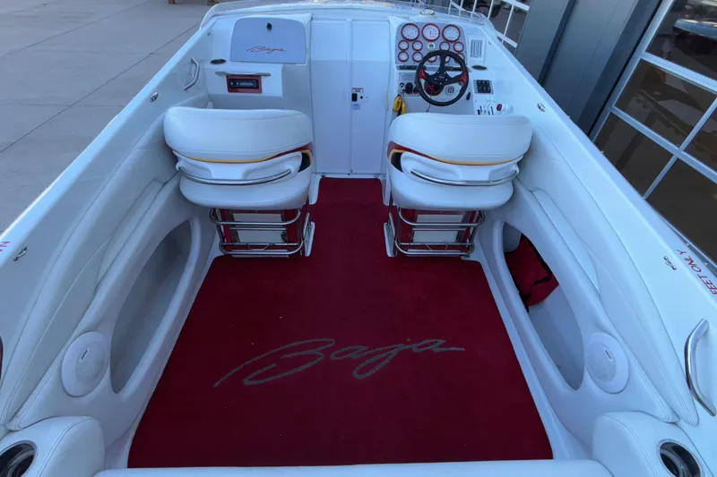 Slide: The Image of 2001 Baja 33 Outlaw boat interior with red carpet and white seating. - 17