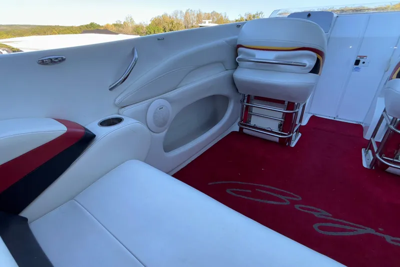 Slide: The Image of 2001 Baja 33 Outlaw boat interior with white seating and red carpet. - 18