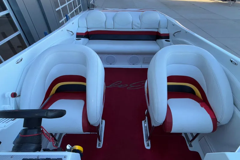 Slide: The Image of 2001 Baja 33 Outlaw boat interior with white and red seating, red carpet, and steering wheel. - 21