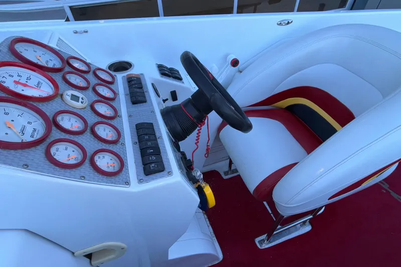 Slide: The Image of 2001 Baja 33 Outlaw boat cockpit with gauges, steering wheel, and colorful seat. - 22