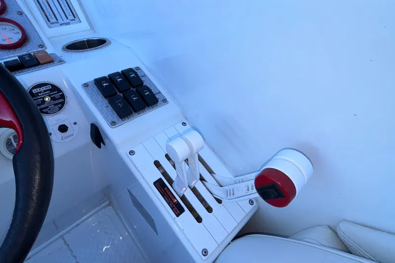 Slide: The Image of 2001 Baja 33 Outlaw boat controls and dashboard with steering wheel and switches. - 26