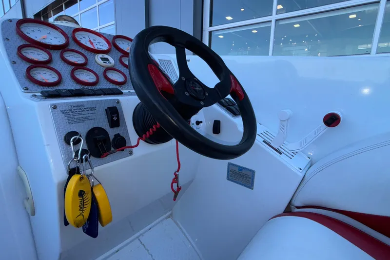 Slide: The Image of 2001 Baja 33 Outlaw boat cockpit with steering wheel and gauges. - 27