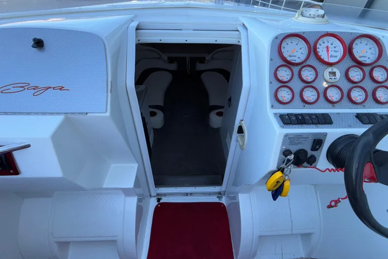 Slide: The Image of 2001 Baja 33 Outlaw boat cockpit with gauges and cabin entrance. - 28