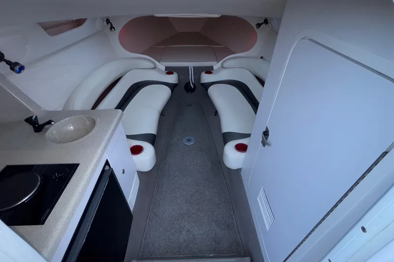 Slide: The Image of 2001 Baja 33 Outlaw boat interior with seating, kitchenette, and modern amenities. - 29