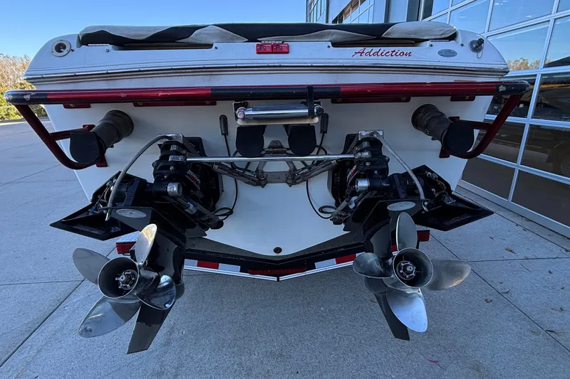 Slide: The Image of 2001 Baja 33 Outlaw boat stern with dual propellers and "Addiction" label. - 3