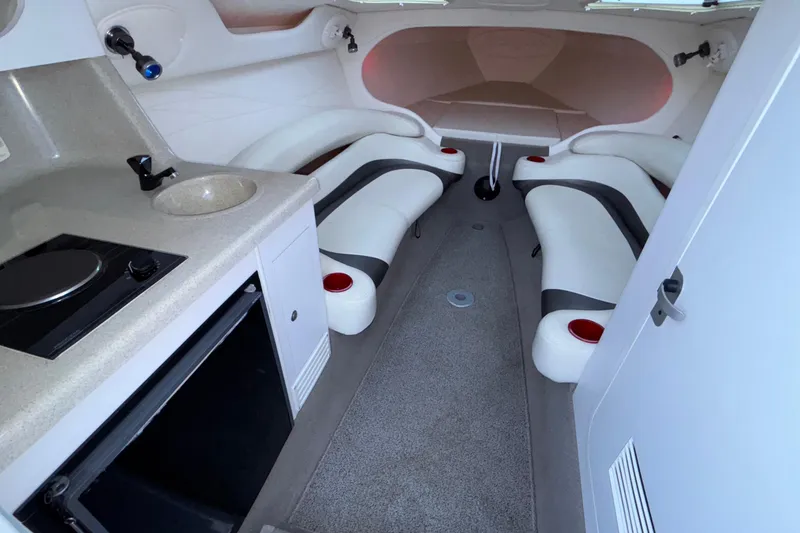 Slide: The Image of 2001 Baja 33 Outlaw cabin interior with kitchenette and seating area. - 30