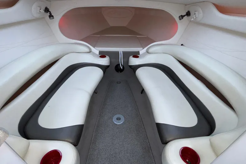 Slide: The Image of 2001 Baja 33 Outlaw boat interior with white and gray seating, red cup holders. - 32