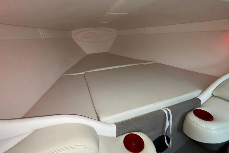 Slide: The Image of Interior cabin of 2001 Baja 33 Outlaw boat with cushioned seating and cup holders. - 33
