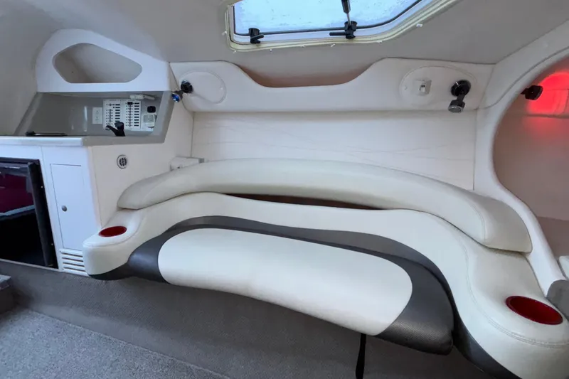 Slide: The Image of Interior of 2001 Baja 33 Outlaw boat with white seating and control panel. - 35