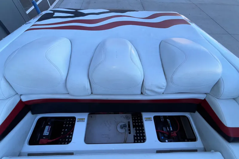 Slide: The Image of 2001 Baja 33 Outlaw boat interior with white cushioned seats and battery compartments. - 7