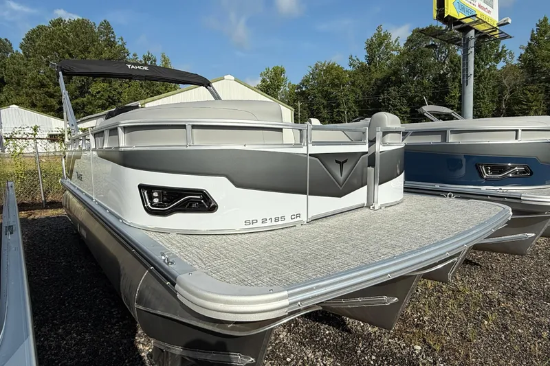 Slide: The Image of 2026 Tahoe Pontoon Sport 85 Cruise boat displayed outdoors, featuring sleek design and modern features. - 2