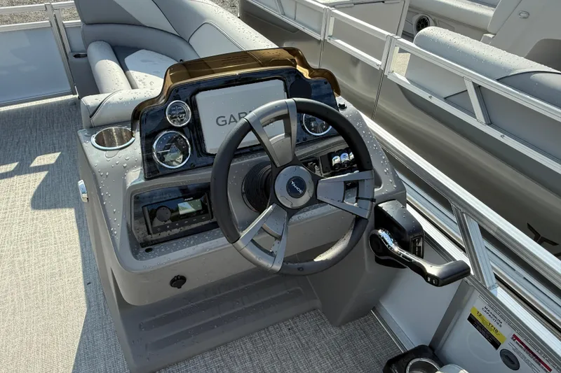 Slide: The Image of 2026 Tahoe Pontoon Sport 85 Cruise dashboard with steering wheel and controls. - 5