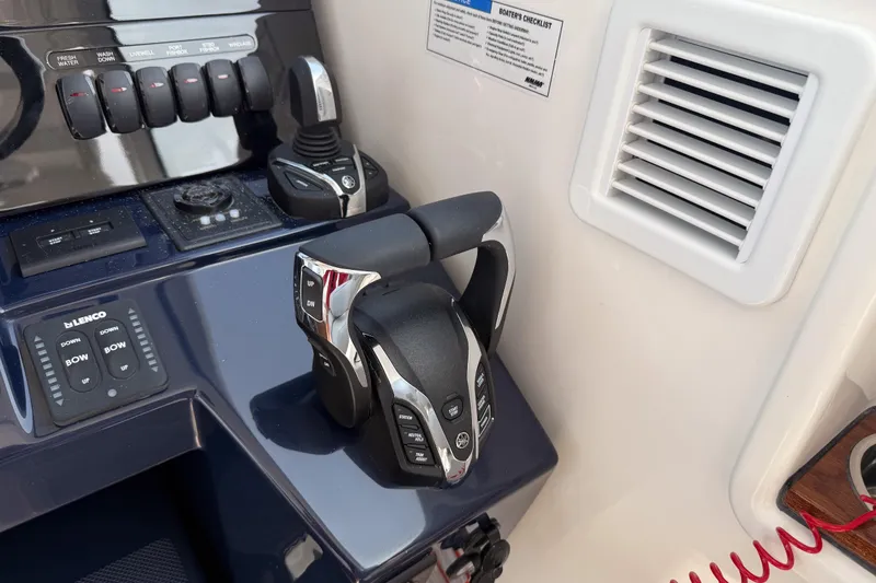 Slide: The Image of Control panel of 2026 Pursuit OS 325 Offshore boat with throttle and switches. - 11