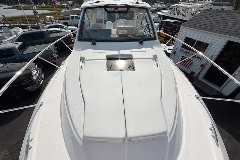 Slide: The Image of 2026 Pursuit OS 325 Offshore boat deck view at marina. - 15