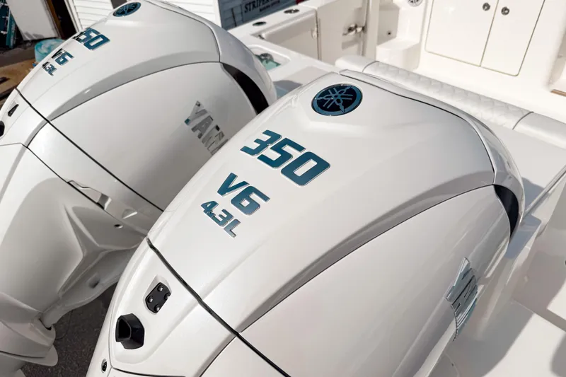 Slide: The Image of Twin Yamaha 350 V6 outboard engines on a 2026 Pursuit OS 325 Offshore boat. - 2