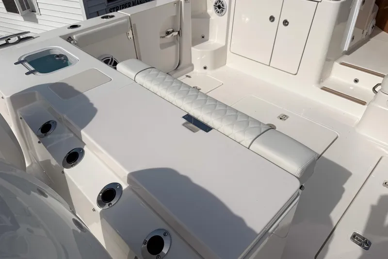 Slide: The Image of 2026 Pursuit OS 325 Offshore boat interior with seating and storage compartments. - 3