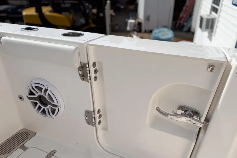 Slide: The Image of 2026 Pursuit OS 325 Offshore boat interior with speaker and door handle detail. - 8