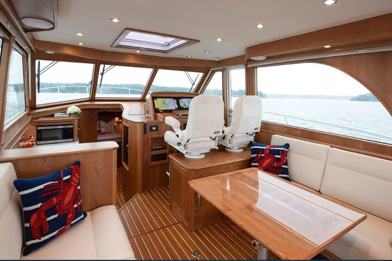 Slide: The Image of 2026 Sabre 45 Salon Express interior with elegant wood finish and modern seating. - 3