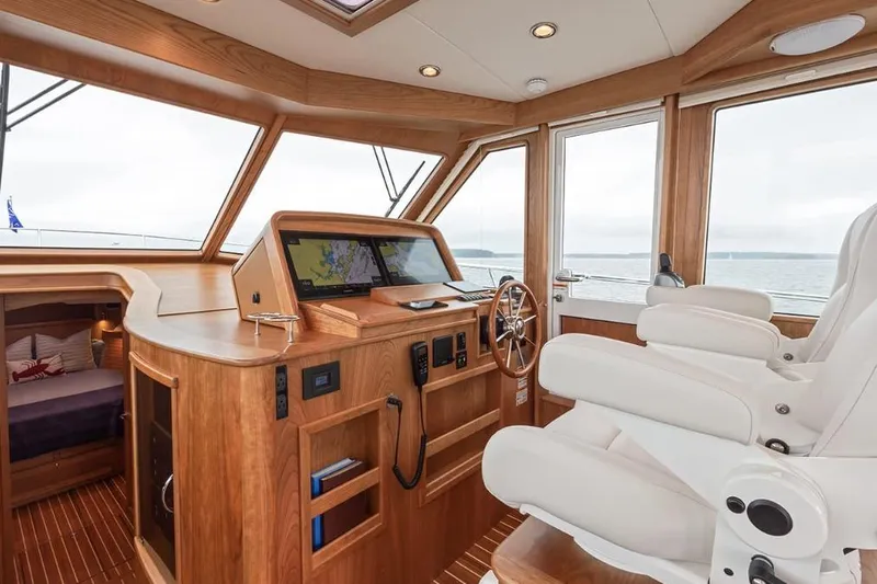 Slide: The Image of Interior of 2026 Sabre 45 Salon Express yacht with luxurious helm and seating. - 4