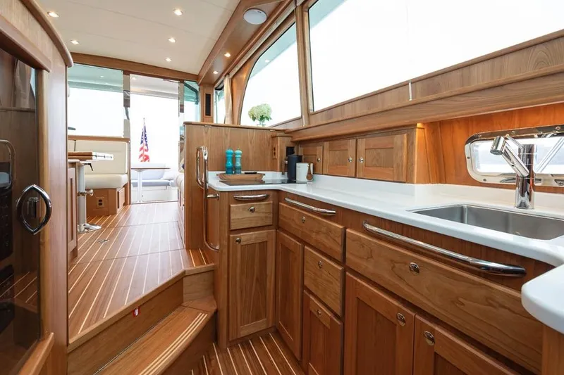 Slide: The Image of Luxurious interior of 2026 Sabre 45 Salon Express yacht with elegant wood cabinetry and modern amenities. - 5