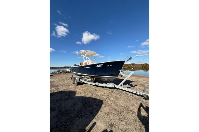 The Image of 2020 Bristol Harbor Vanquish boat on trailer under clear blue sky. - 1
