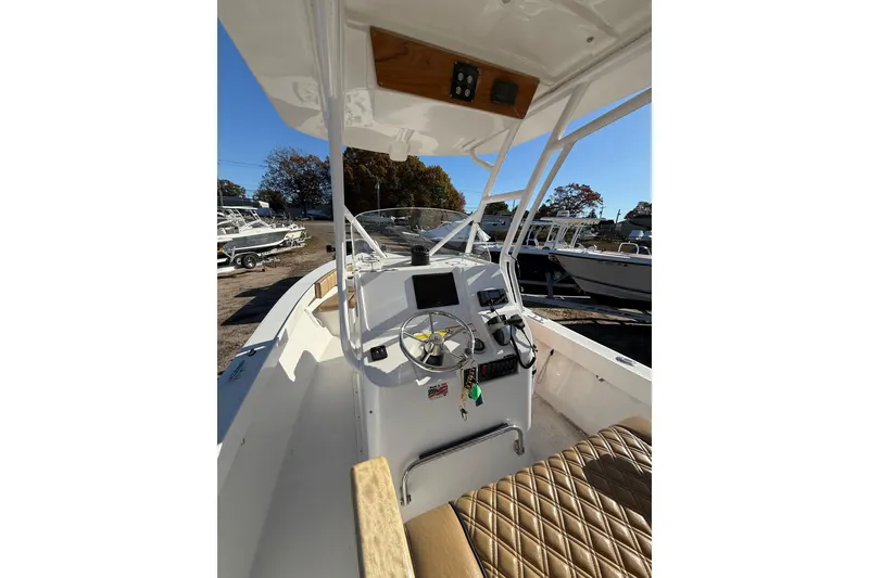 Slide: The Image of 2020 Bristol Harbor Vanquish boat interior with steering console and seating. - 14