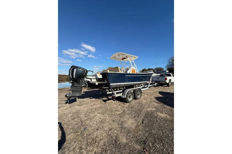 Slide: The Image of 2020 Bristol Harbor Vanquish boat on trailer, parked outdoors under clear blue sky. - 2