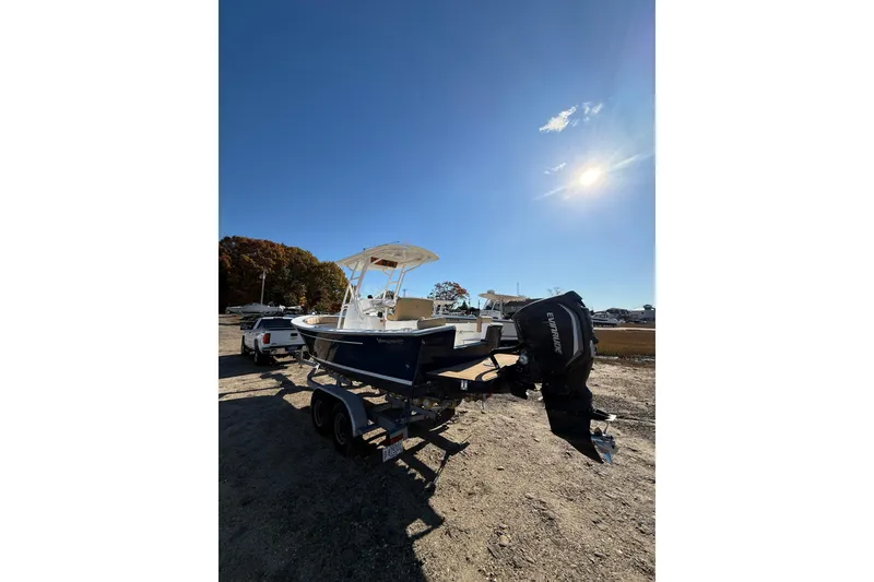Slide: The Image of 2020 Bristol Harbor Vanquish boat on trailer under clear blue sky. - 4