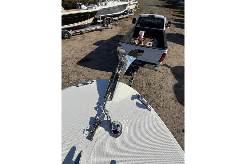 Slide: The Image of 2020 Bristol Harbor Vanquish boat hitched to a pickup truck in a boatyard. - 7