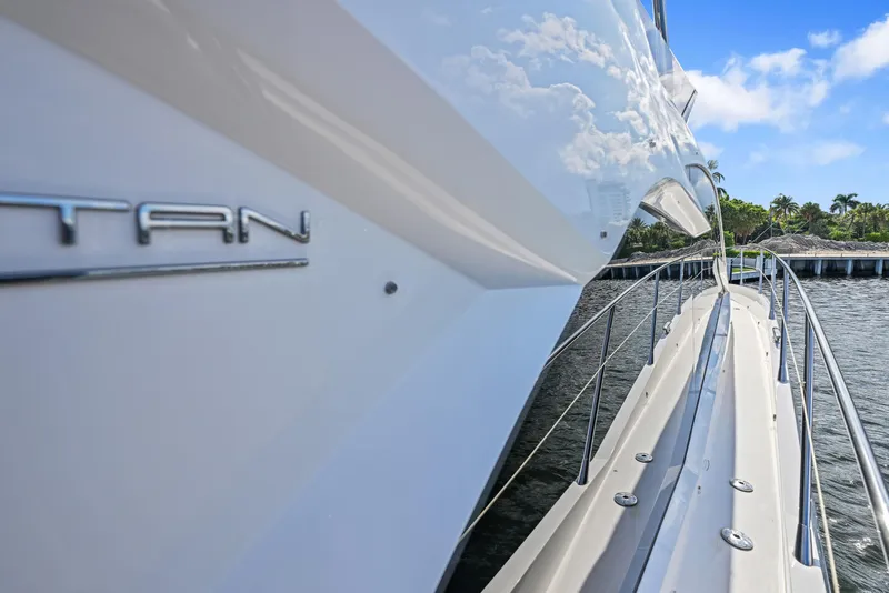 Slide: The Image of 2020 Sunseeker Manhattan 52 yacht, sleek design, docked by waterfront, clear blue sky. - 11