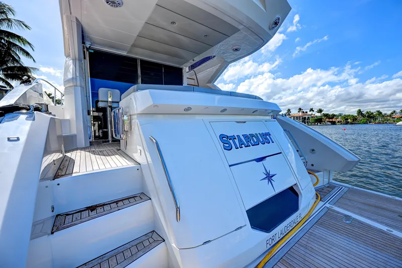 Slide: The Image of 2020 Sunseeker Manhattan 52 yacht docked, featuring "Stardust" nameplate, Fort Lauderdale. - 12