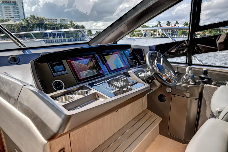 Slide: The Image of 2020 Sunseeker Manhattan 52 yacht helm with advanced navigation systems and luxurious interior. - 25