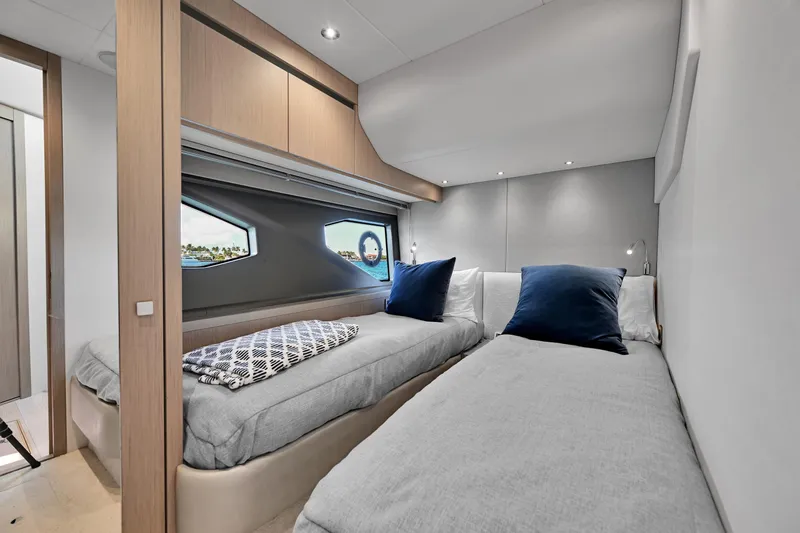 Slide: The Image of Luxurious cabin interior of 2020 Sunseeker Manhattan 52 yacht with twin beds and modern decor. - 28