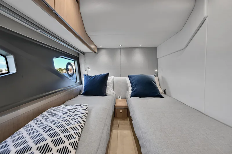 Slide: The Image of Luxurious cabin interior of 2020 Sunseeker Manhattan 52 yacht with twin beds and modern decor. - 29