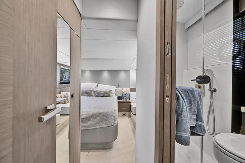 Slide: The Image of Luxurious interior of 2020 Sunseeker Manhattan 52 yacht, featuring a modern bedroom and bathroom. - 36