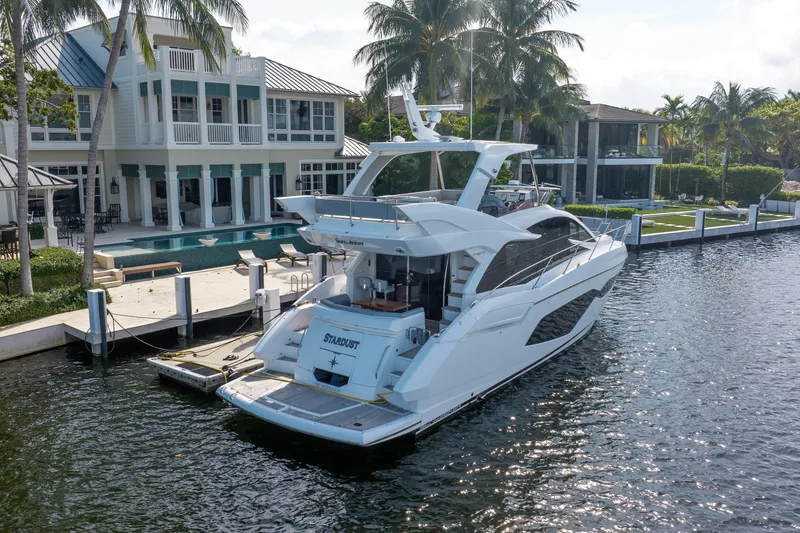 Slide: The Image of Luxury Sunseeker Manhattan 52 yacht docked by waterfront mansion, 2020 model. - 4