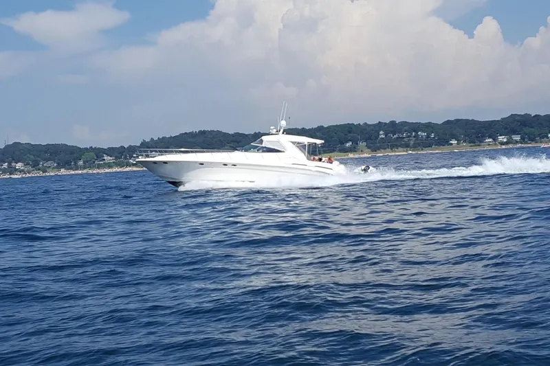 The Image of 1998 Sea Ray 540 Sundancer cruising on open water under a partly cloudy sky. - 1