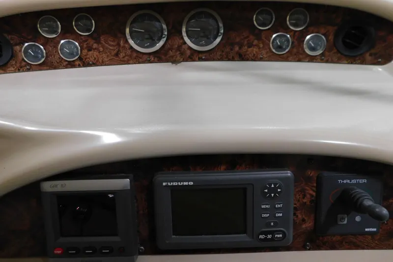 Slide: The Image of Control panel of a 1998 Sea Ray 540 Sundancer with gauges and navigation equipment. - 13