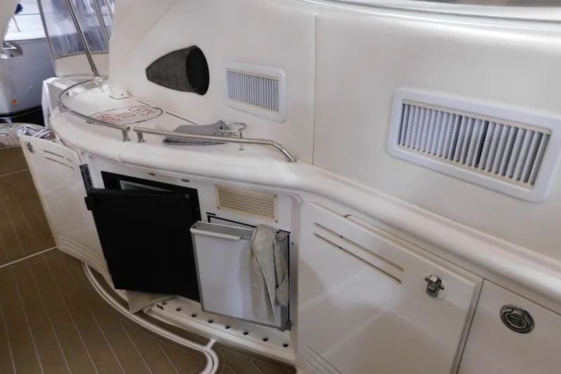 Slide: The Image of 1998 Sea Ray 540 Sundancer yacht interior with open storage compartments and sleek design. - 15