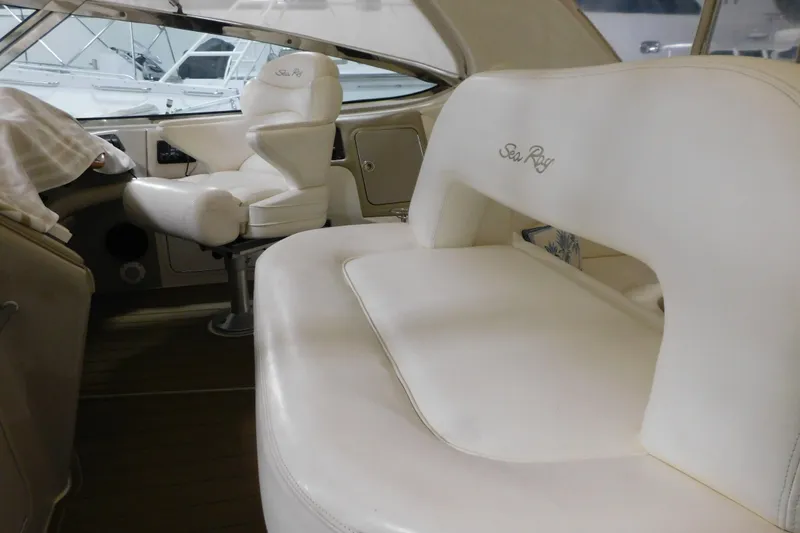 Slide: The Image of 1998 Sea Ray 540 Sundancer interior with white leather seating and helm chair. - 17