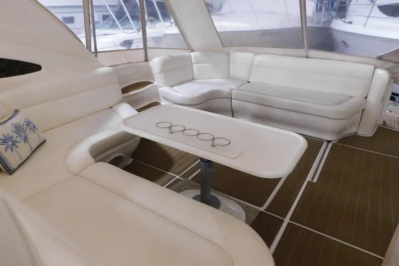 Slide: The Image of Luxurious interior of 1998 Sea Ray 540 Sundancer yacht with white seating and table. - 18