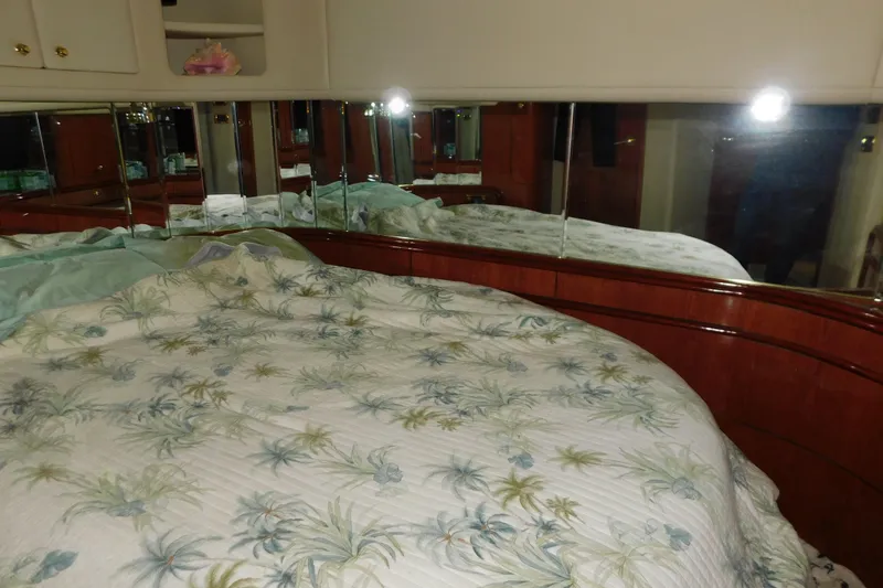 Slide: The Image of Luxurious bedroom interior of 1998 Sea Ray 540 Sundancer yacht with floral bedding. - 22