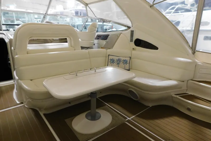 Slide: The Image of Luxurious interior of 1998 Sea Ray 540 Sundancer yacht with white seating and table. - 26