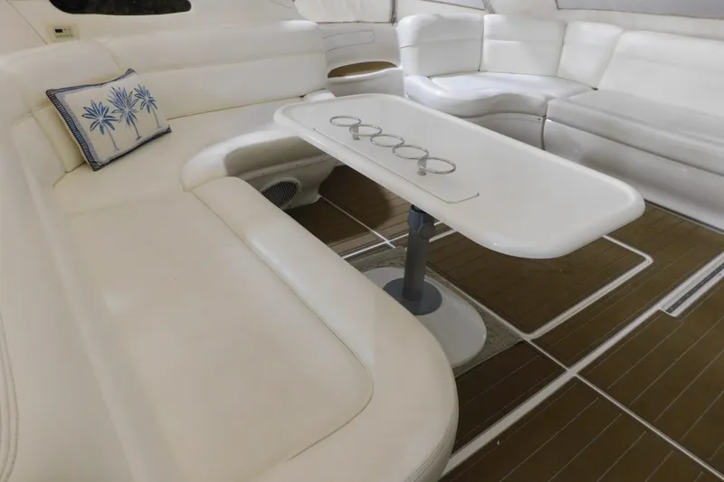 Slide: The Image of Luxurious interior of 1998 Sea Ray 540 Sundancer yacht with white seating and table. - 28