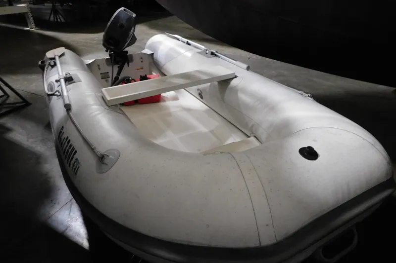 Slide: The Image of Inflatable boat with motor, indoors, associated with 1998 Sea Ray 540 Sundancer. - 31