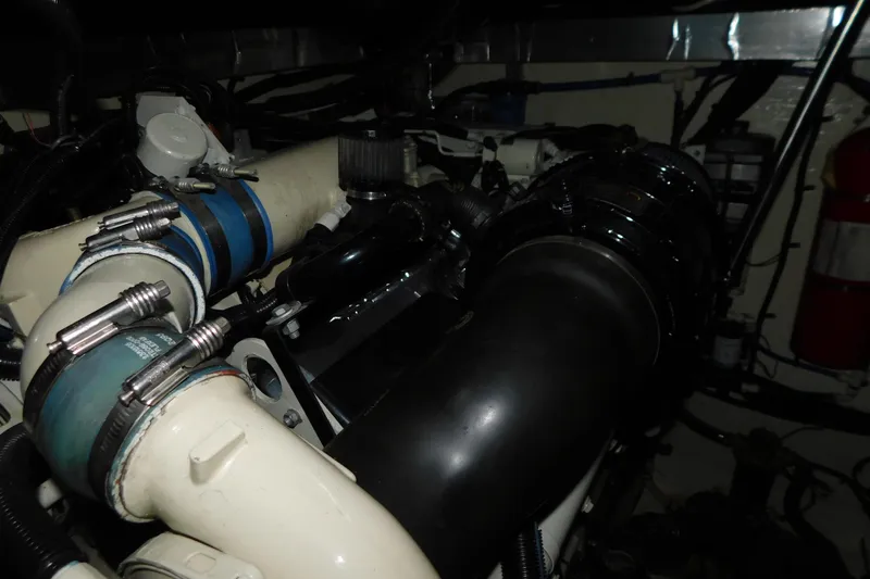 Slide: The Image of Engine compartment of a 1998 Sea Ray 540 Sundancer with visible hoses and components. - 34