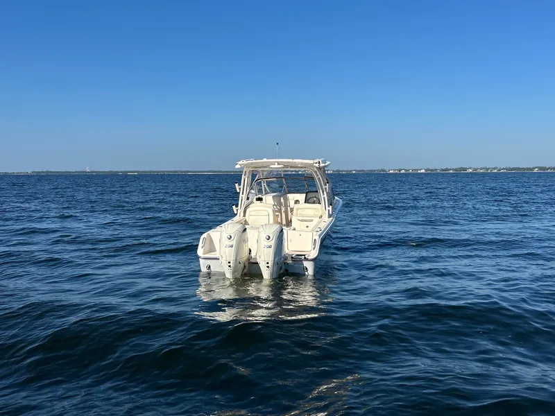 Slide: The Image of A 2026 Grady-White Freedom 275 boat floats on calm water under a clear sky. - 6