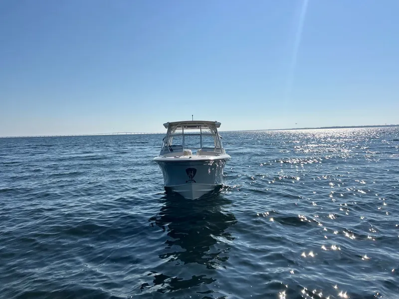 Slide: The Image of A 2026 Grady-White Freedom 275 boat on calm water under a clear sky. - 4