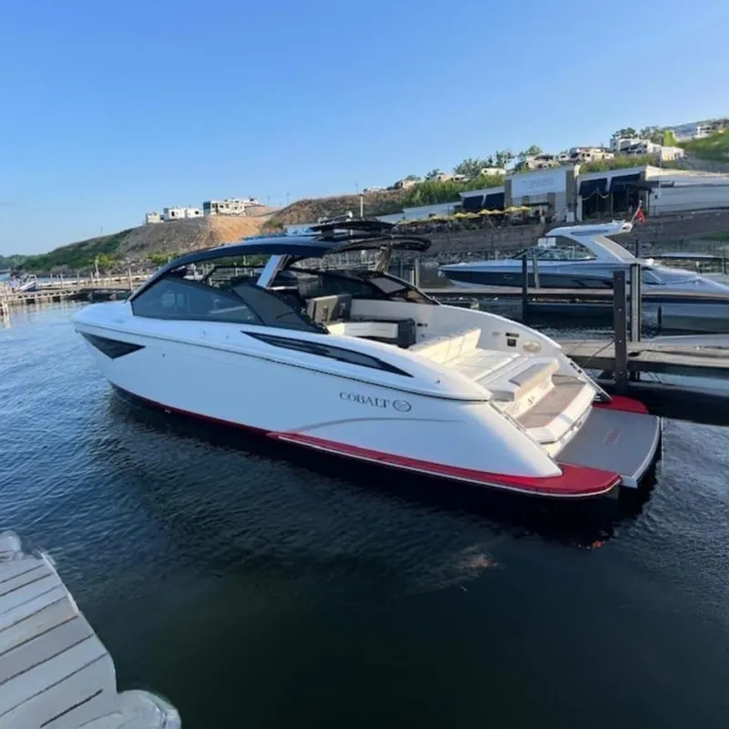 The Image of 2021 Cobalt A36BR boat docked on a sunny day, showcasing sleek design. - 0